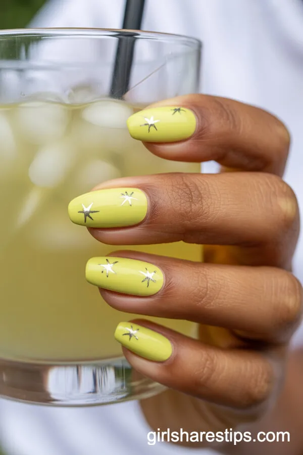 Short Almond Pastel Yellow Nails with Silver Star Accents