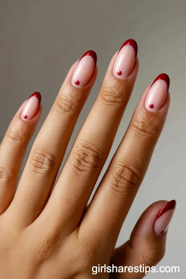 Blush Pink Oval Nails with Red French Tips and Dot Accents