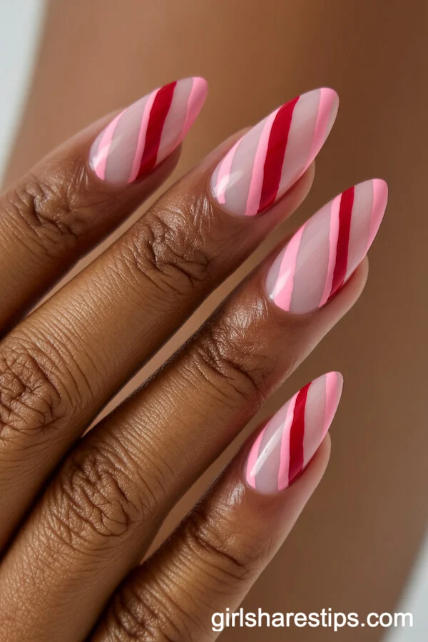 Nude Almond Nails with Pink and Red Diagonal Stripes
