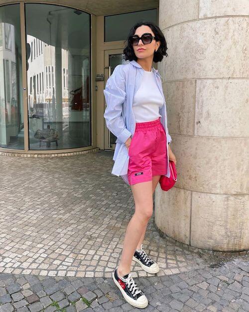 blue button down, pink shorts and canvas sneakers