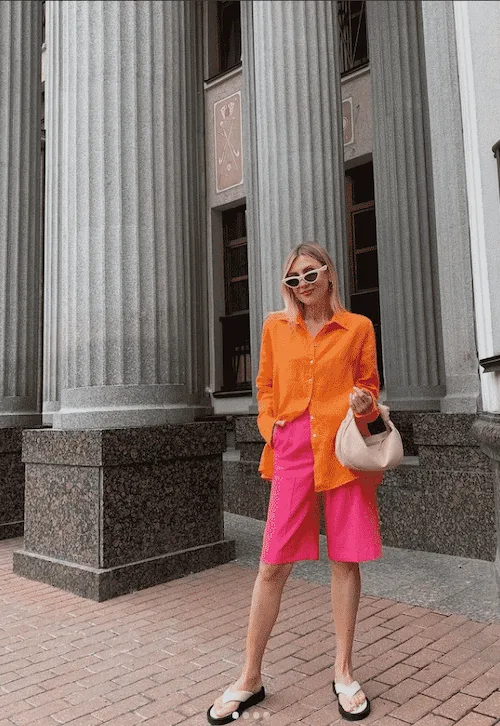 orange top and long pink shorts