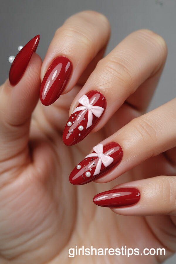 Glossy Cherry Red Almond Nails with Coquette Bow Details