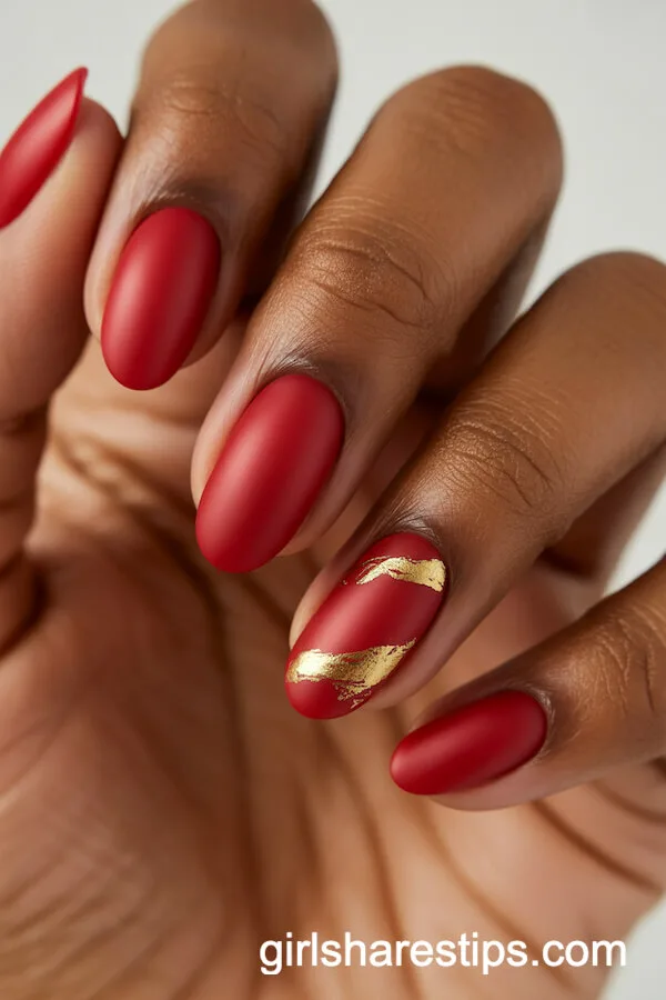 Matte Red Oval Nails with Gold Foil Accents