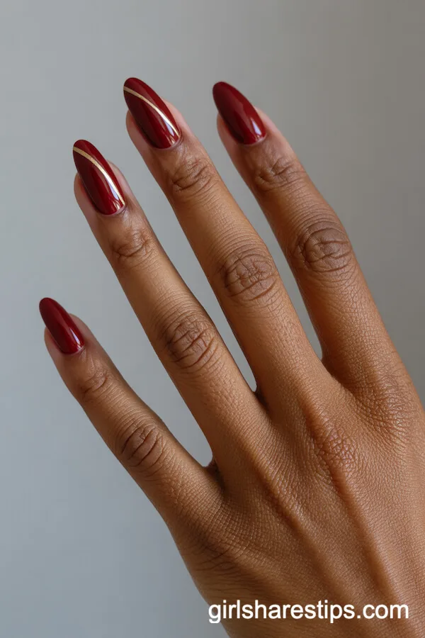 Minimalist Almond Red Nails with Thin Gold Lines