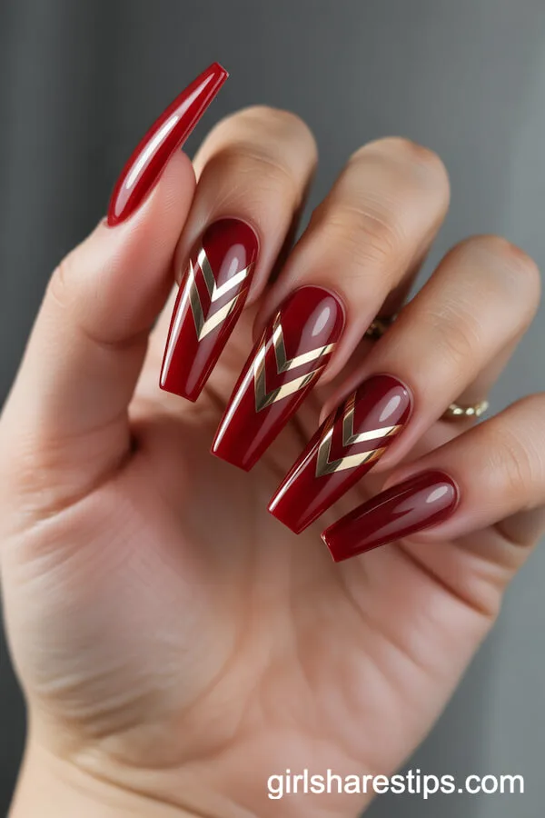 Coffin Red Nails with Dramatic Gold Chevron Patterns