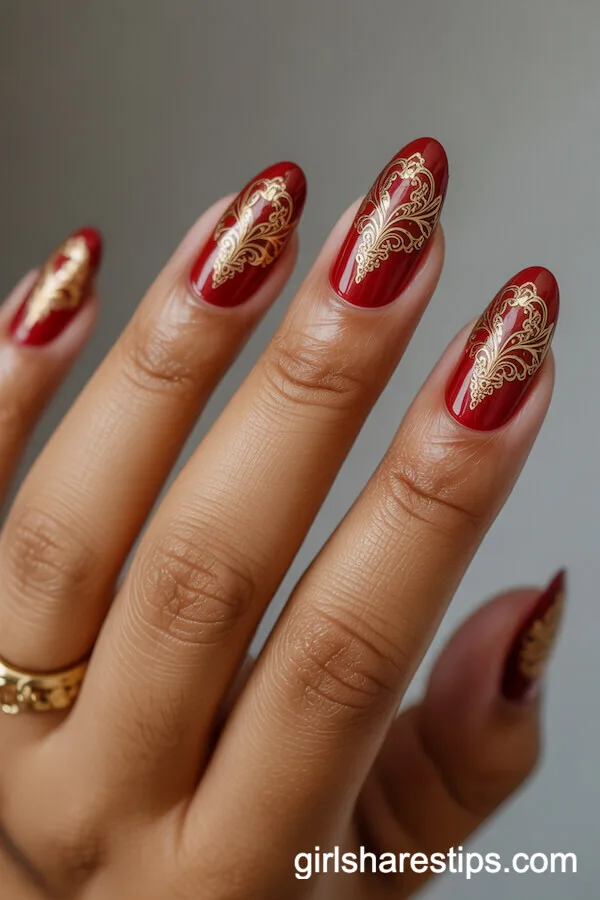 Oval Red Nails with Intricate Gold Filigree Designs