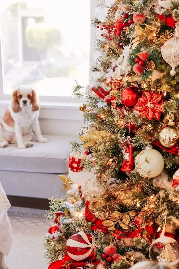 Red and Gold Christmas Tree with Floral Accents and Ribbons