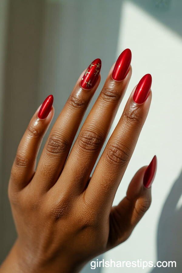 Red Chrome Almond Nails With Gold Star Accent