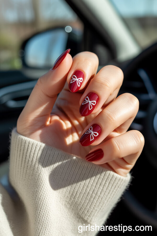 Deep Red Almond Nails With Minimalist White Bow Designs