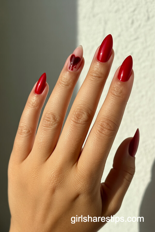 Deep Red Pointed Nails with a 'Dripping' Black Heart