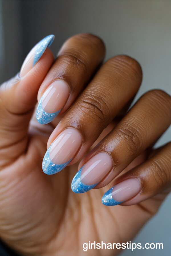 Short Almond Nails With Nude Base and Baby Blue Glitter Tips