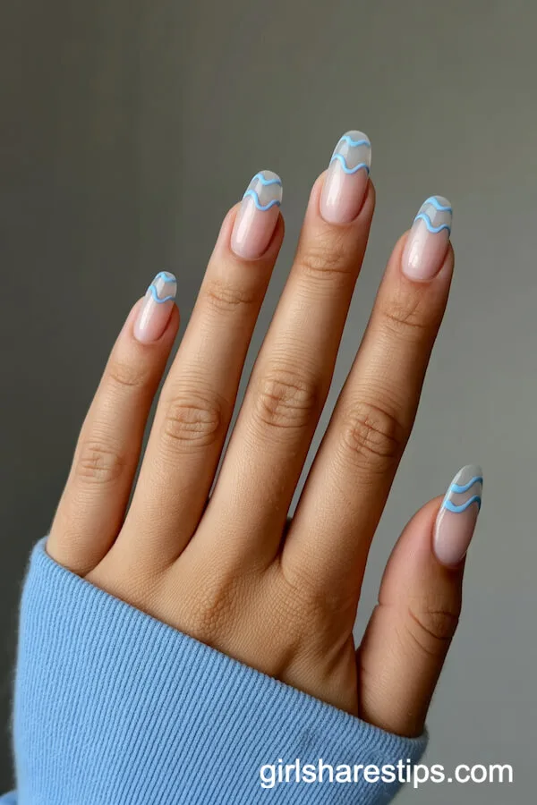 Short Squoval Nails With Clear Base and Baby Blue Wavy Lines