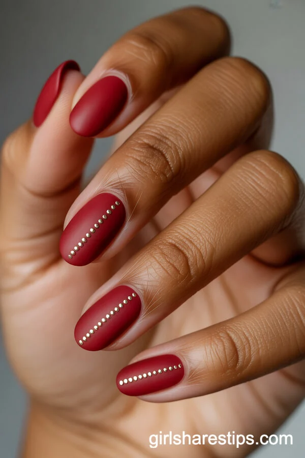Matte Red Oval Nails with Central Metallic Micro-Stud Lines