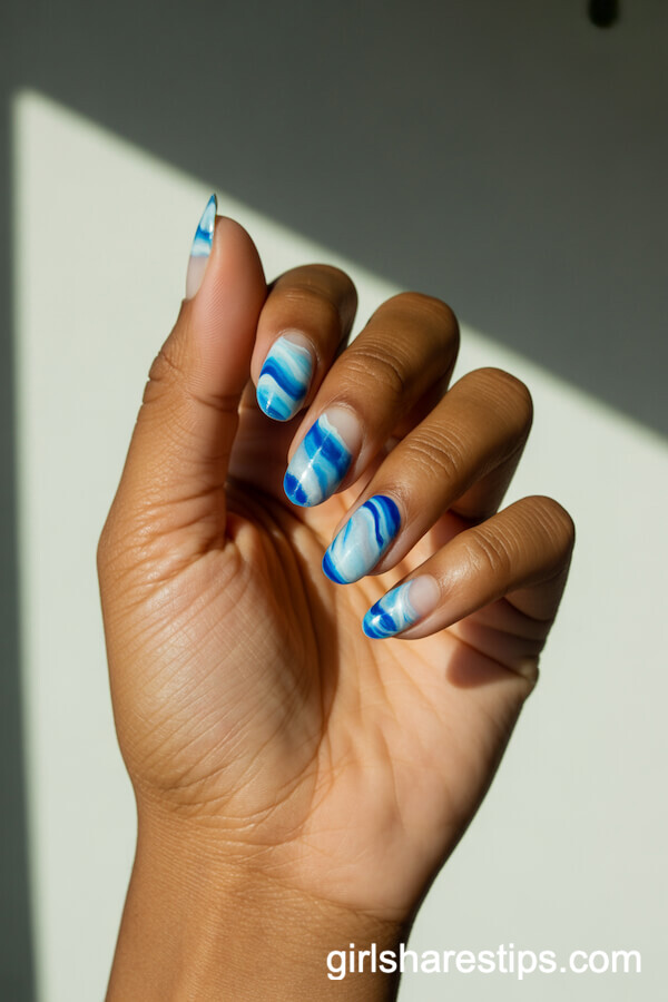 Blue and White Swirled Ocean Waves Nail Design
