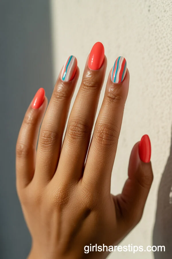 Vibrant Coral Nails with Bold White and Turquoise Stripes