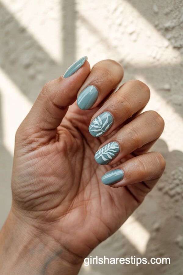 Blue Nails with Tropical Leaf Art