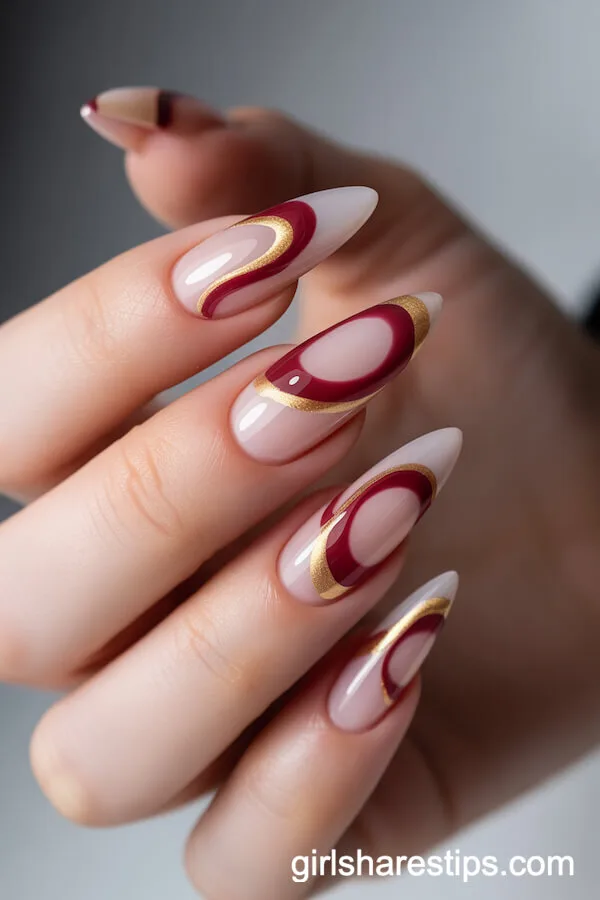 Translucent Maroon and Gold Swirl Stiletto Nails