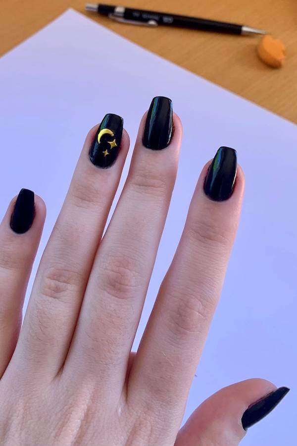 Black Nails with Gold Moon and Star Accents