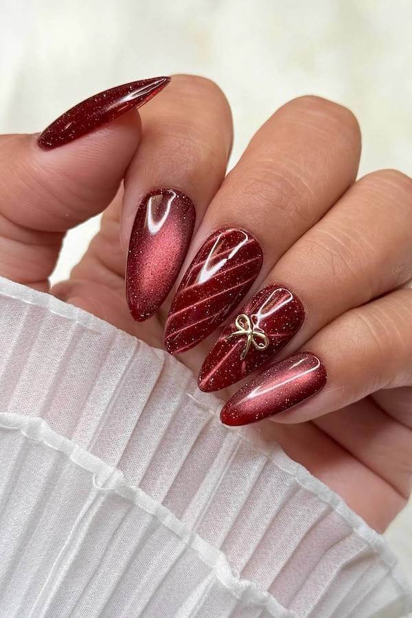 Shimmery Red Nails With Bow Charm