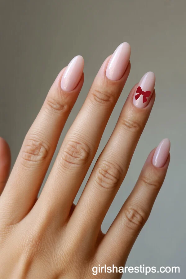 Soft Pink Almond Nails with Minimal Red Mickey Bow