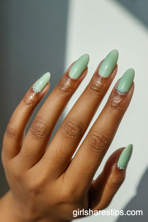 Glossy Mint Green Almond Nails with Silver Crystal Accents