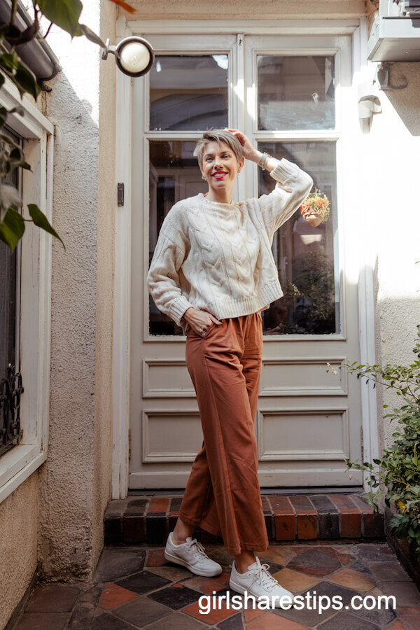 Cable-Knit Sweater with Rust Pants and Sneakers