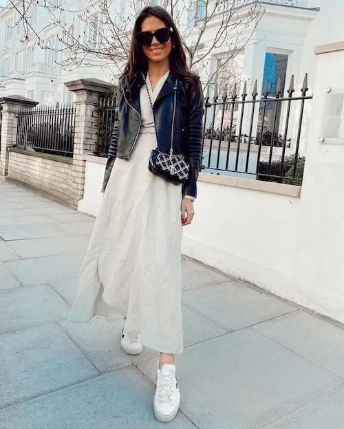 a white linen dress, a pair of white sneakers, and a black leather jacket