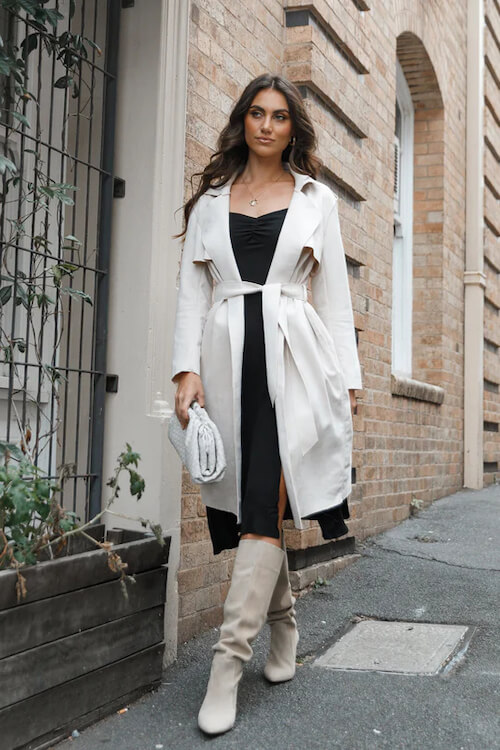 white trench coat and a long black dress