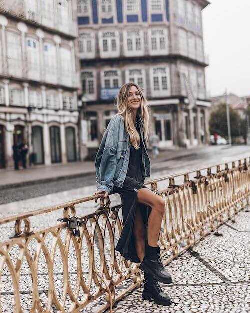 a denim jacket, a black long dress, and a pair of black boots