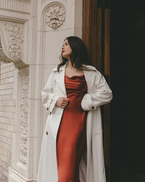 a perfect fall date night look with a long silky dress and a white trench coat