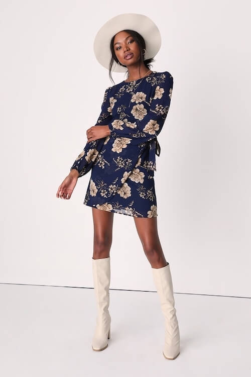 a black girl wearing a navy floral dress and white boots to a winter bridal shower