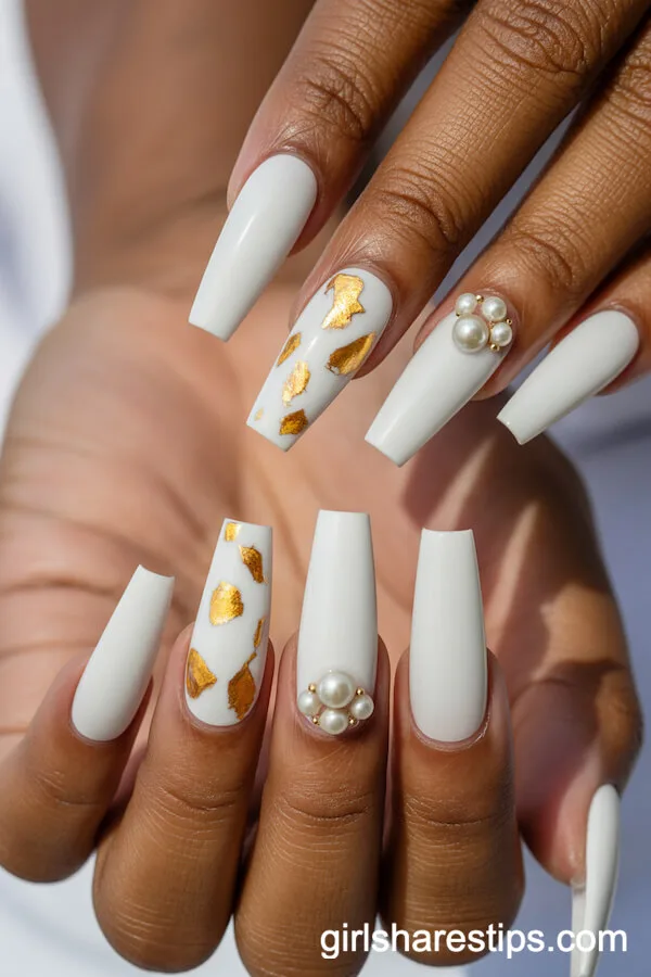 Long Coffin Nails with Gold Flakes and Pearl Embellishments