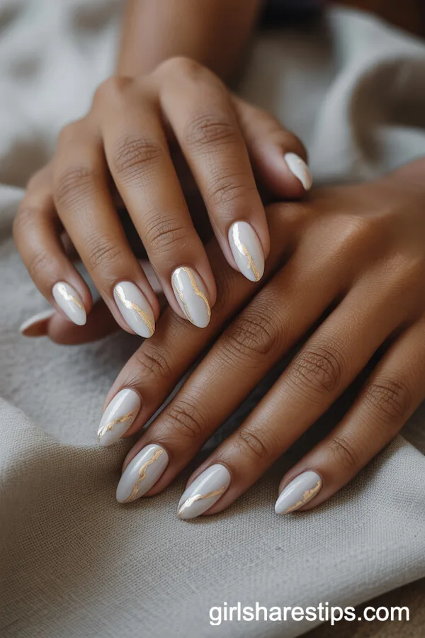 White Almond Nails with Delicate Gold Foil Accents