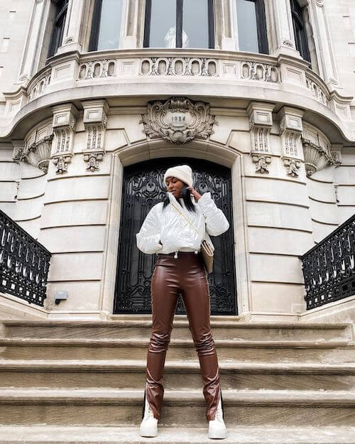 a black woman wearing white puffer jacket outfit