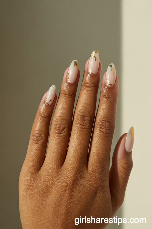 Glossy White Almond Nails with Gold Leaf Flake Base